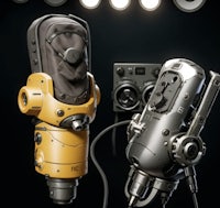 two microphones in front of a dark background