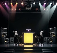 a stage with speakers and a yellow table